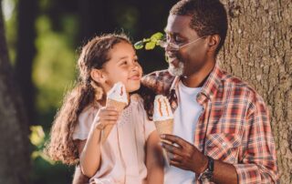 A girl and a man enjoying Branson Ice Cream.
