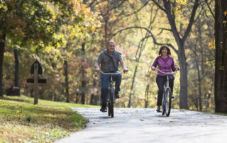View of couple biking on a sunny day enjoying Branson, MO, monthly weather