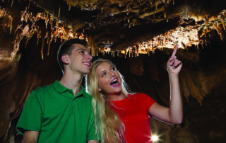 Two people walking through the caves in Branson MO