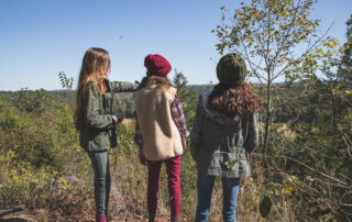 cheap things to do in Branson: Group of girls sightseeing on Ozarks hiking trail