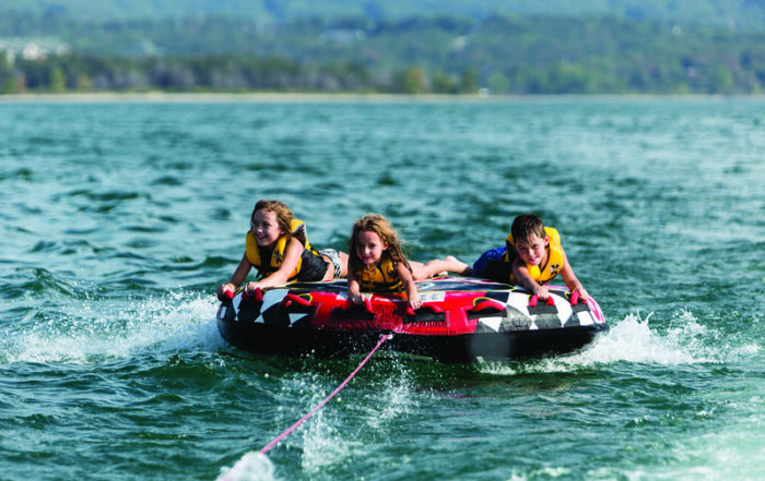 Kids on a tube while boating on Table Rock Lake in summer